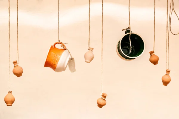 Cups and clay pots hanging on the ropes, the design and interior