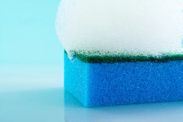 Sponge with  foam and reflection, bubbles, close-up, texture, light blue background