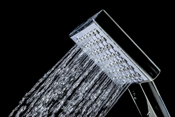 Shower with jets of water close up isolated on a black background