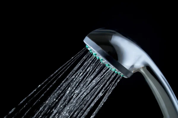 Shower with jets of water close up isolated on a black background