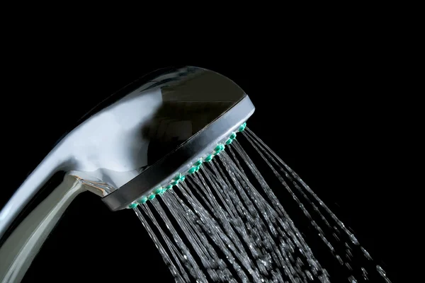 Shower with jets of water close up isolated on a black background