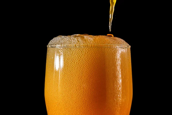 Orange soda large glass, overflowing glass of orange soda closeup with bubbles isolated