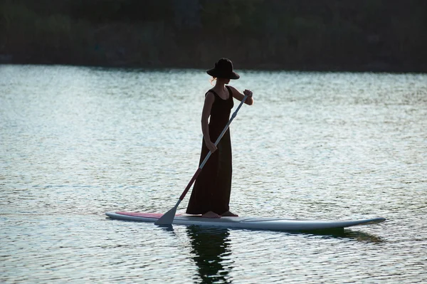 Silhouette of a beautiful woman on stand up paddle board. SUP02