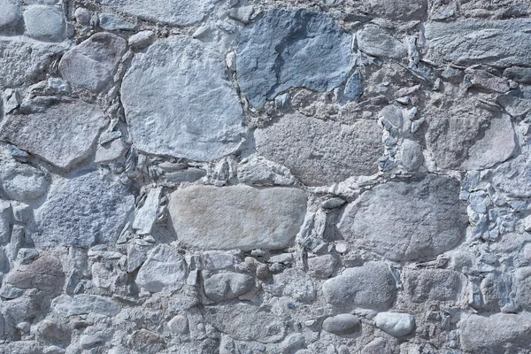 Old masonry wall of natural stones different sizes