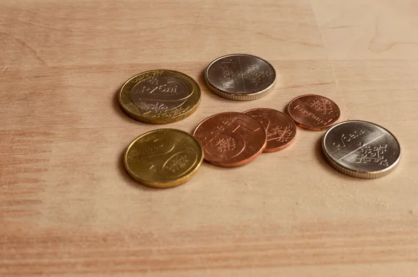 Coins on wooden desk. New Belarus coins. Front sides