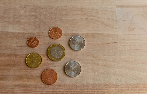 Coins on wooden desk. New Belarus coins. Front and back sides