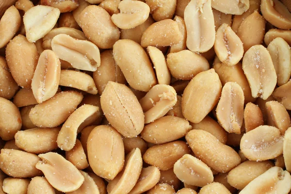 Food background - salted roasted peanuts situated arbitrarily