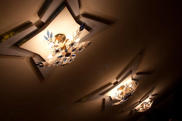 Fragment of home entrance interior illuminated by ceiling light