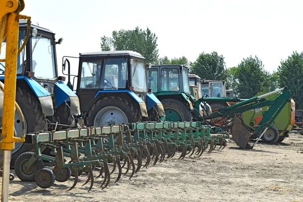 Tractor, standing in a row. Agricultural machinery.