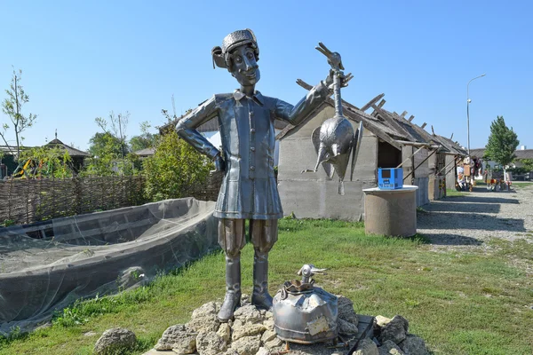 Metal statue of a Cossack holding a crane