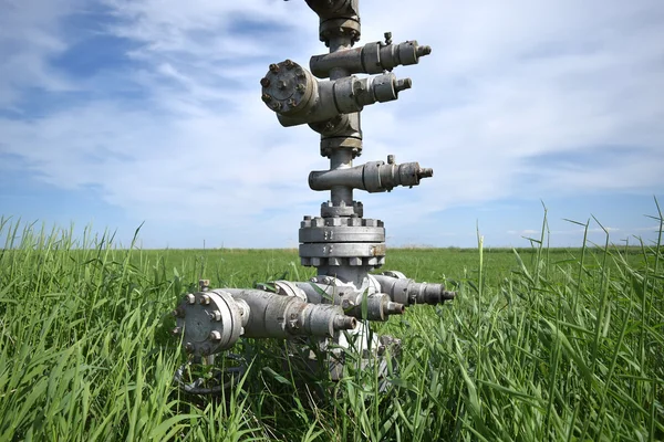 Canned oil well against the sky and field