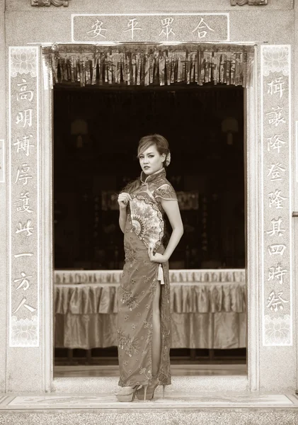Woman in Chinese dress pose in retro style