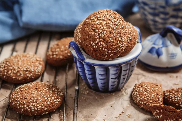 Fresh baked oatmeal cookies with sesame seeds in a cup. Sesame c