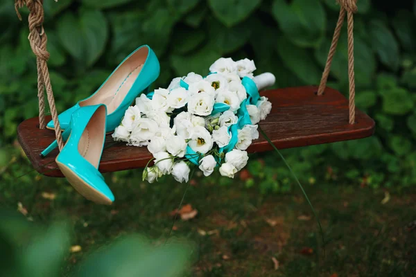 Wedding bouquet of white roses and blue ribbons and blue patent