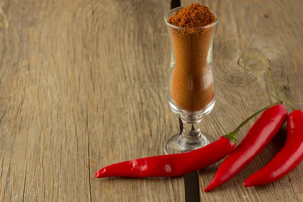 Chili pepper and chili powder in small glass