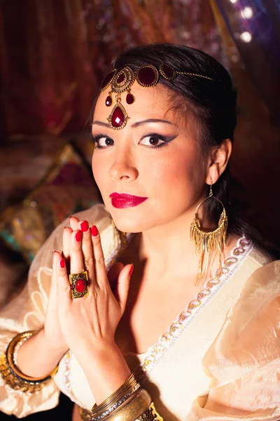 Portrait of beautiful Oriental woman prays