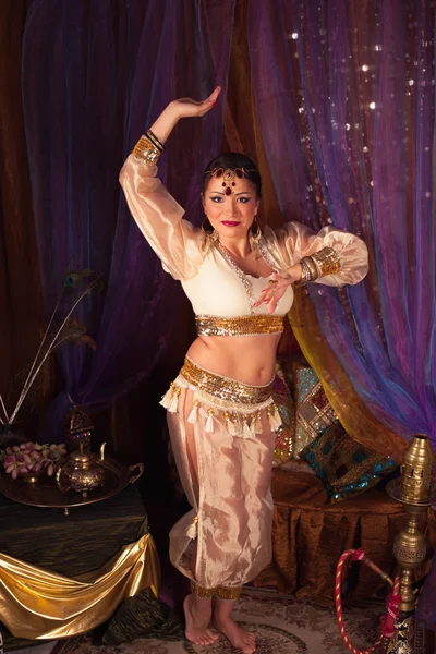 Beautiful eastern woman dancing belly dance in a beautiful dress