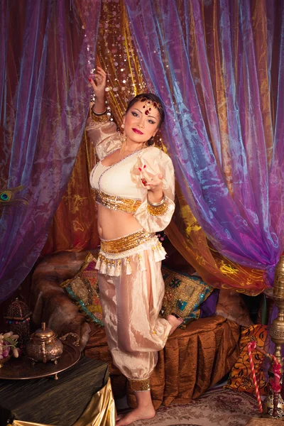 Beautiful eastern woman dancing belly dance in a beautiful dress