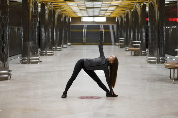 Young woman working out in an urban setting, a series yoga poses