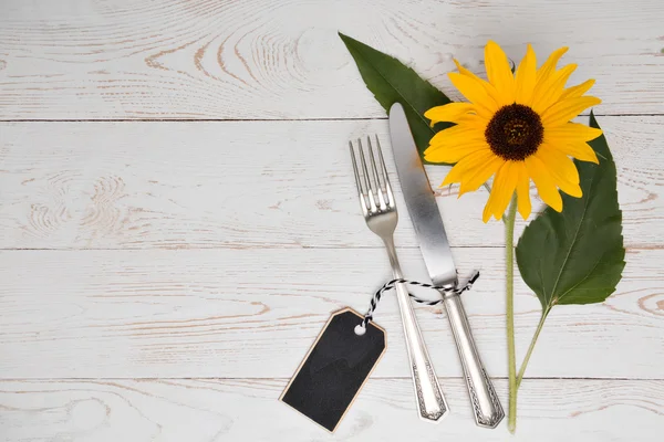 Silverware with sunflower on a table