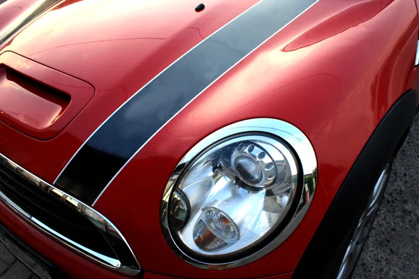 Red and small sport car - isolated part with headlight and blink