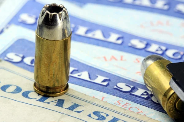 Ammunition bullets laying on social security card