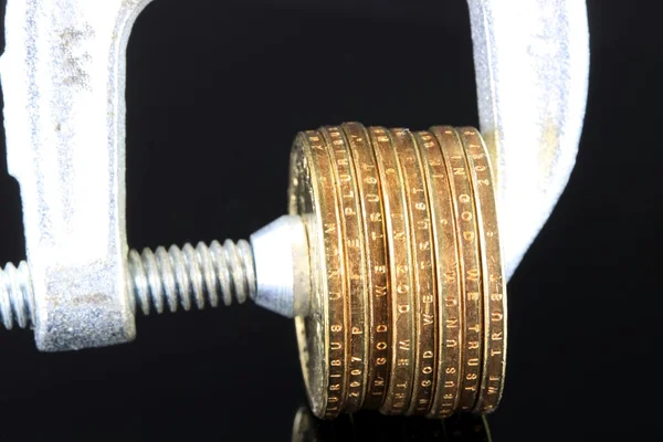 Budget Crisis US Currency Gold Coins in Vise Clamp