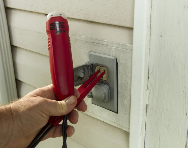 Electrician Testing A Outside Outlet