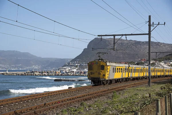 Costal line passenger train passing Kalk Bay in the Western cape South Africa