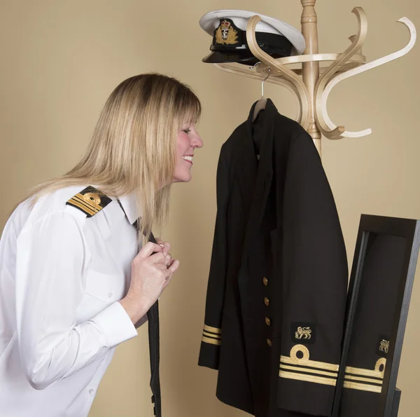 Female naval officer getting dressed into her uniform