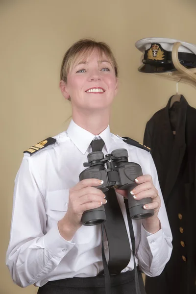 Female naval officer using binoculars