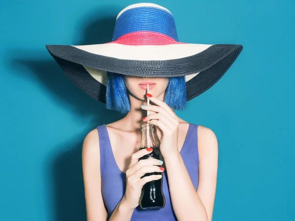 Beautiful young Woman in Hat drink soda