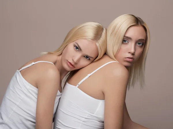 Two young beautiful woman twins