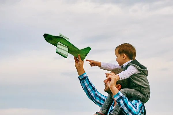 Happy father with son playing with toy plane. dream to be a pilot