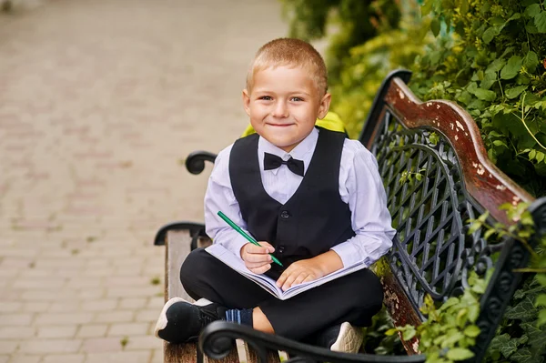 Cute boy student in the Park .Preschool education