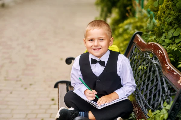 Cute boy student in the Park .Preschool education