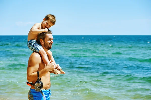 Happy father and son playing at sea . Father\'s day