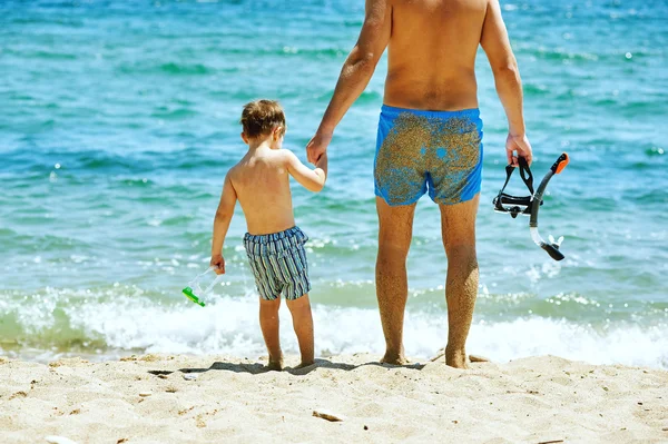 Happy father and son playing at sea . Father\'s day