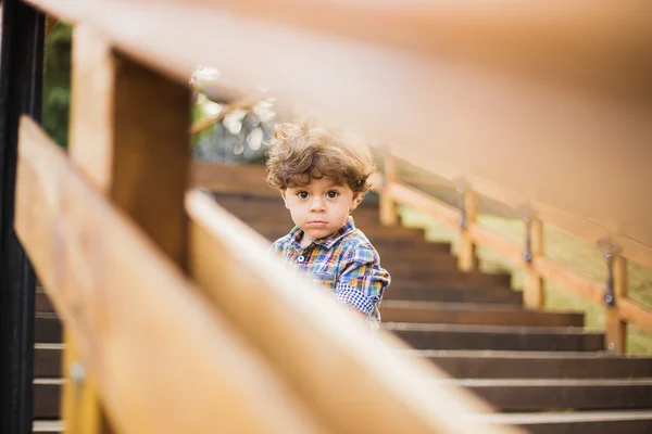 Portrait of cute child sitting on wood stairs