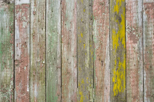 Close-up picture of wood wall. The wall is old and  with peeling paint