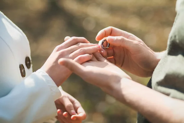 Wedding rings. Hands of bride and groom