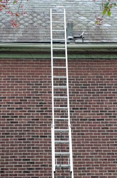 Ladder Against Slate Roof With Tools