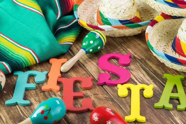 Mexican fiesta table decoration with colorful fiesta maracas, sombreros.