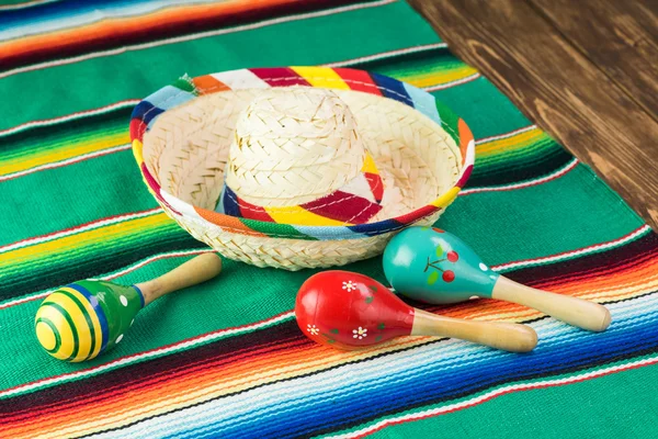 Mexican fiesta table decoration with colorful fiesta maracas, sombrero.