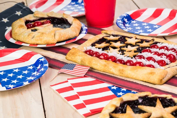 Fresh homemade blueberry pies, decorated with stars, cherry and