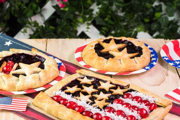 Fresh homemade blueberry pies, decorated with stars, cherry and