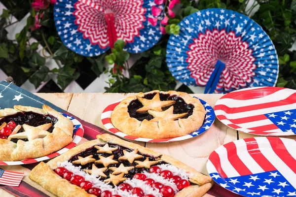 Fresh homemade blueberry pies, decorated with stars, cherry and