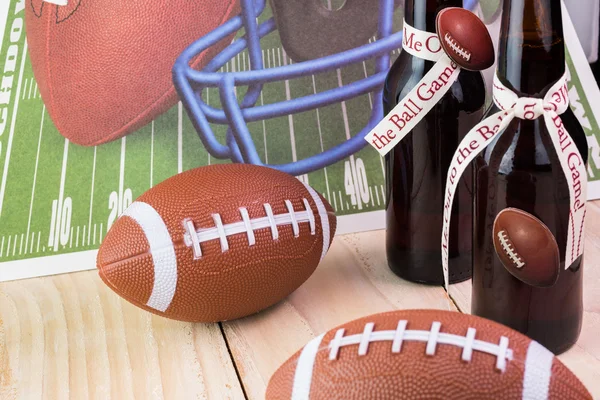 Bottles of beer, decorated for football game party table.