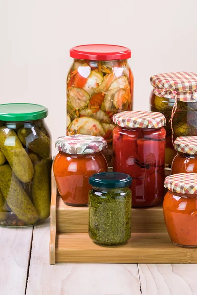 Assorted vegetable pickles in glass jars and roasted red pepper