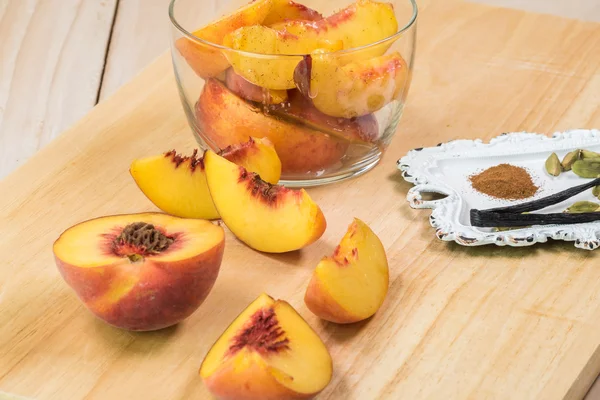 Fresh sliced peaches and spices for filling of peach galette.